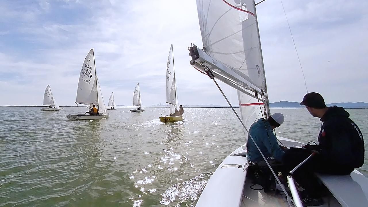 View from a Snipe racing upwind with the fleet ahead